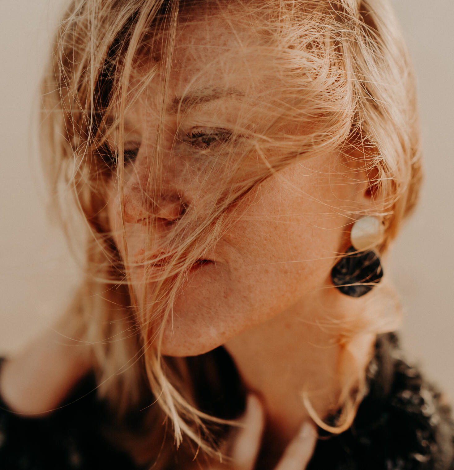 close up picture of a women wearing big and Elegant statement earrings handmade by Norvelia design.