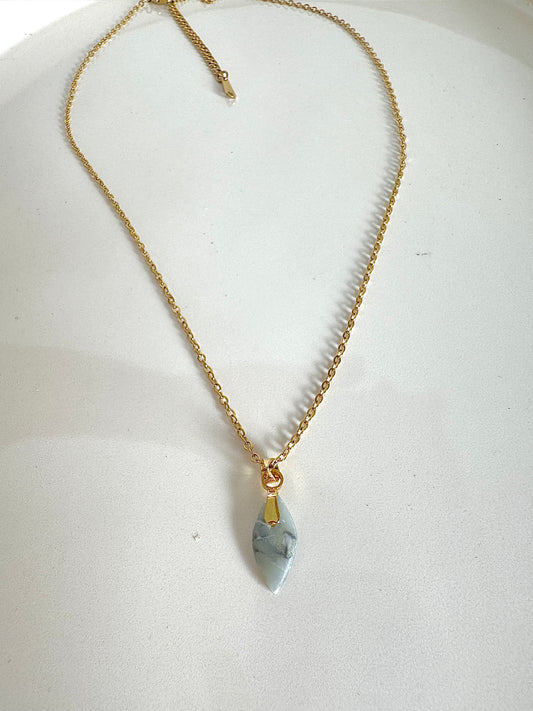 golden necklace with small petal pendant in crystal blue marbled