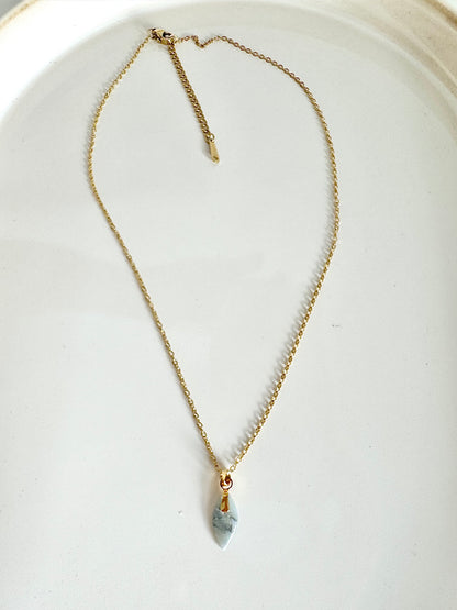 golden necklace with small petal pendant in crystal blue marbled